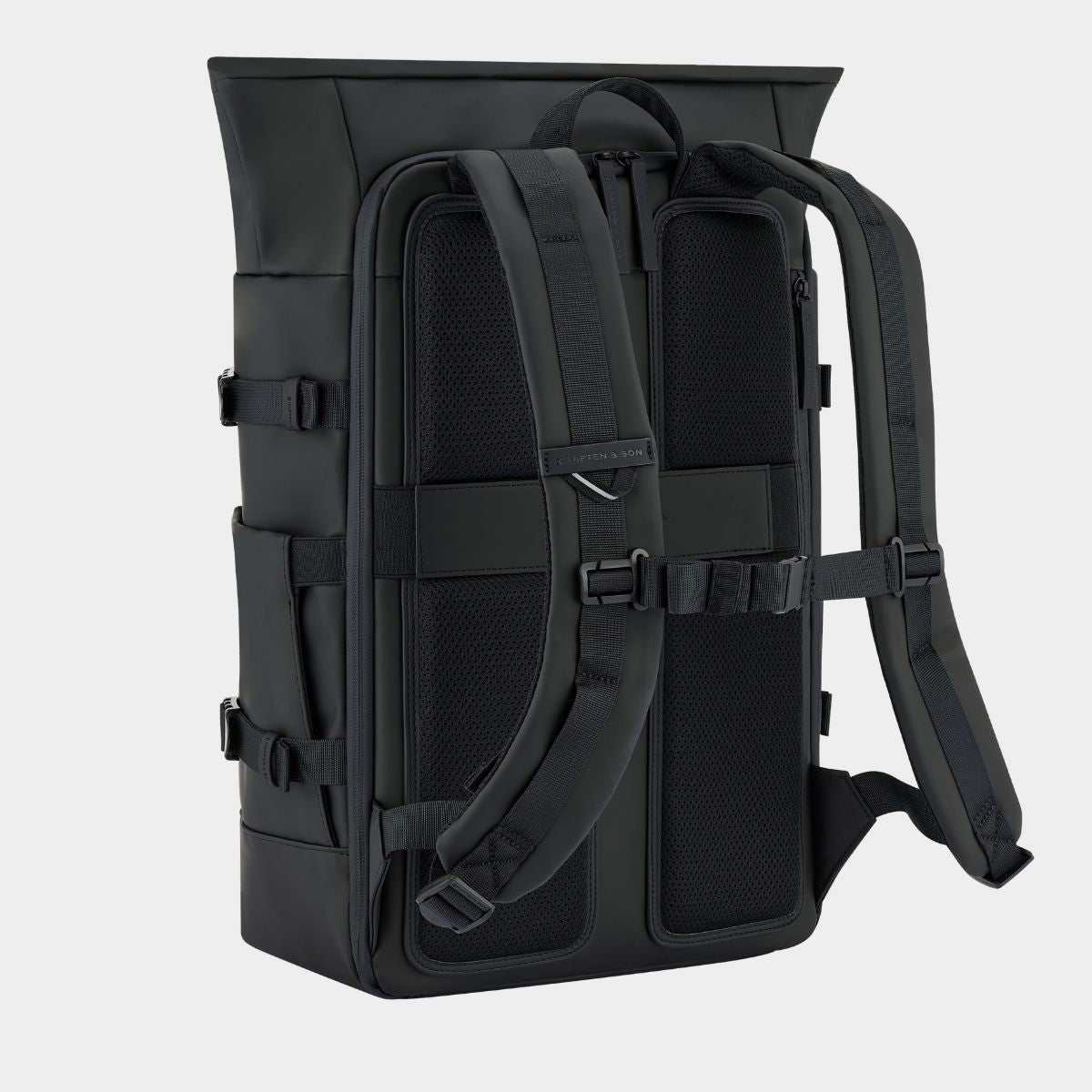 A black tactical backpack shown from the back, featuring padded shoulder straps, compression buckles, and mesh ventilation panels, set against a light gray background.