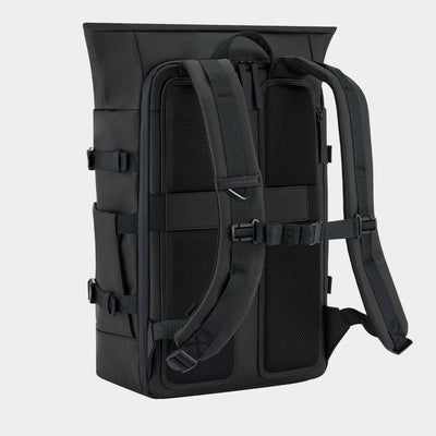 A black tactical backpack shown from the back, featuring padded shoulder straps, compression buckles, and mesh ventilation panels, set against a light gray background.