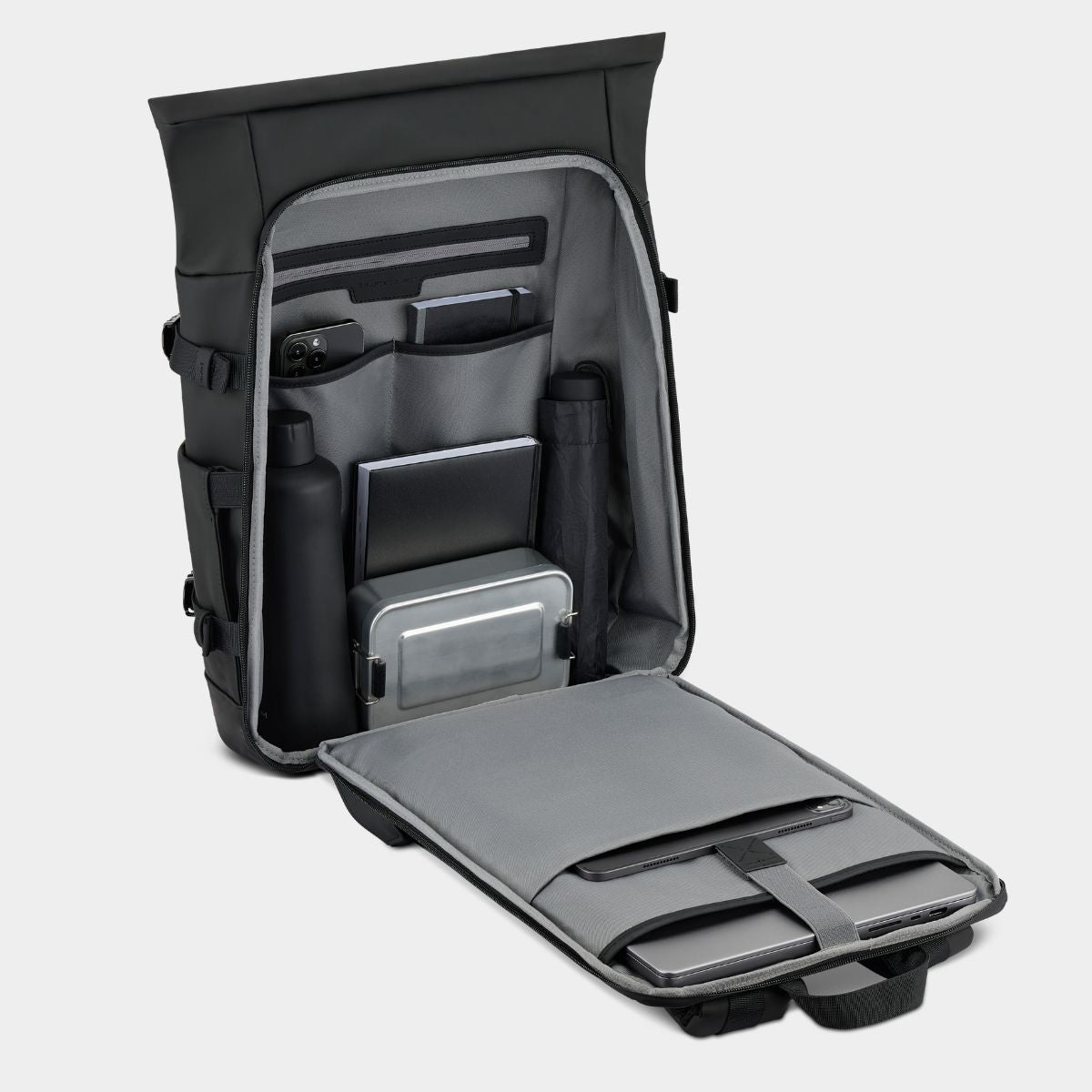 Black and gray backpack with compartments on a gray background