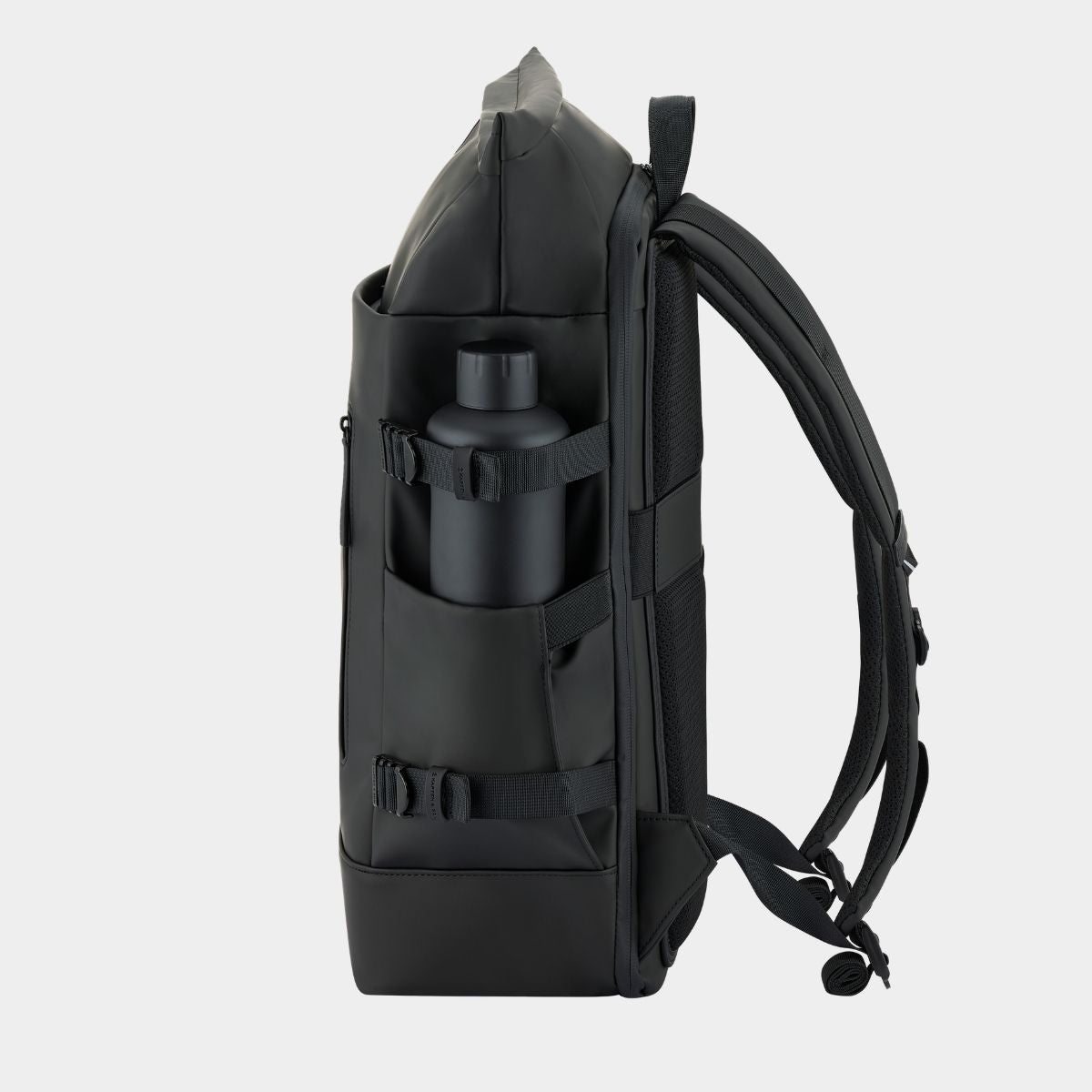 A black tactical backpack shown from the side, featuring a side pocket holding a matching black water bottle, set against a light gray background.