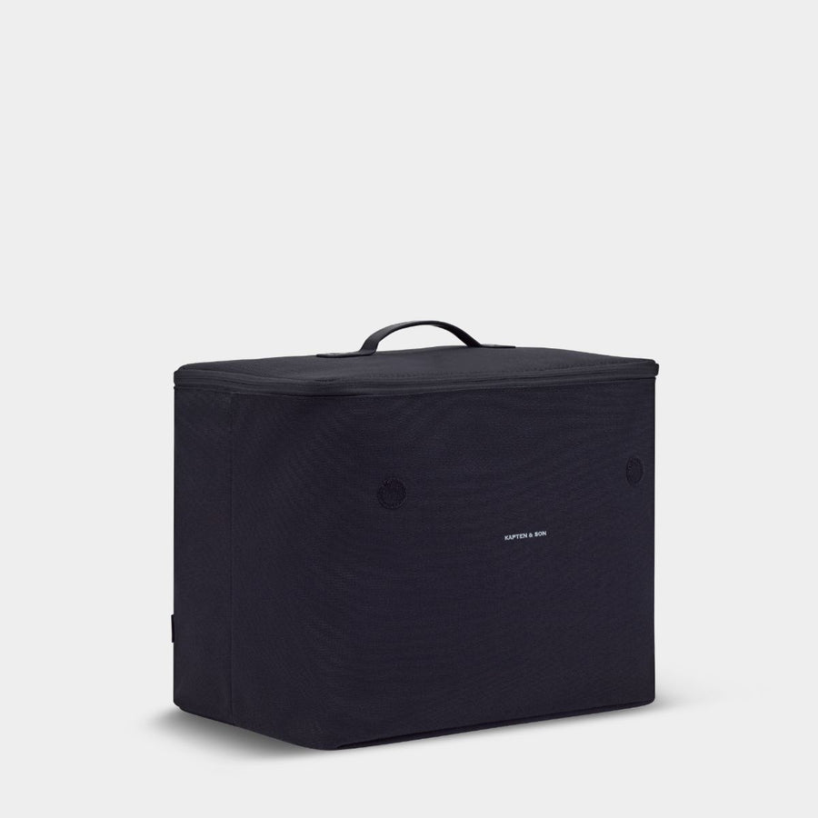 Black soft sides container against. light gray background with "KAPTEN & SON" logo written in white. Zipper closure with a top handle.