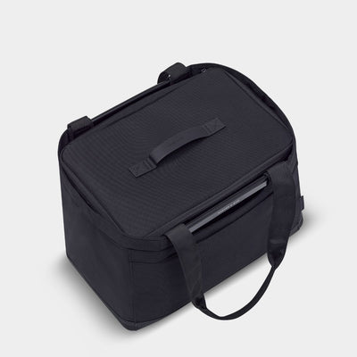 Black soft sides container inside a black basket of the same color with a shoulder strap.. Zipper closure with a top handle.
