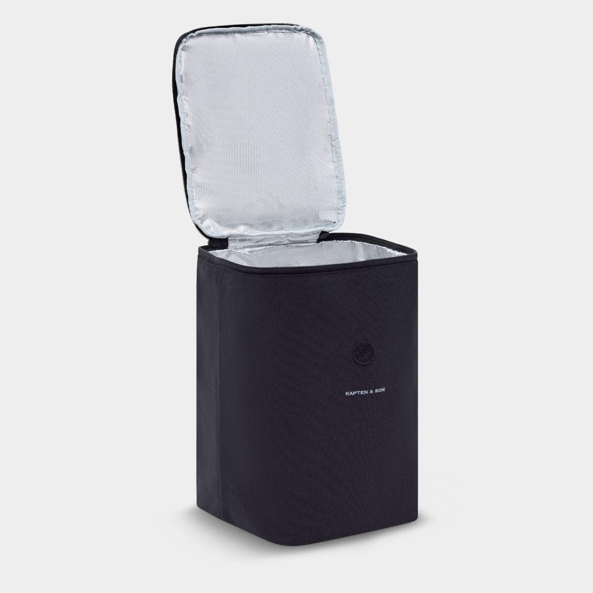 A black insulated cooler bag with its lid open, showing a silver reflective lining, on a light gray background. The brand name 'Kapten & Som is visible on the front.