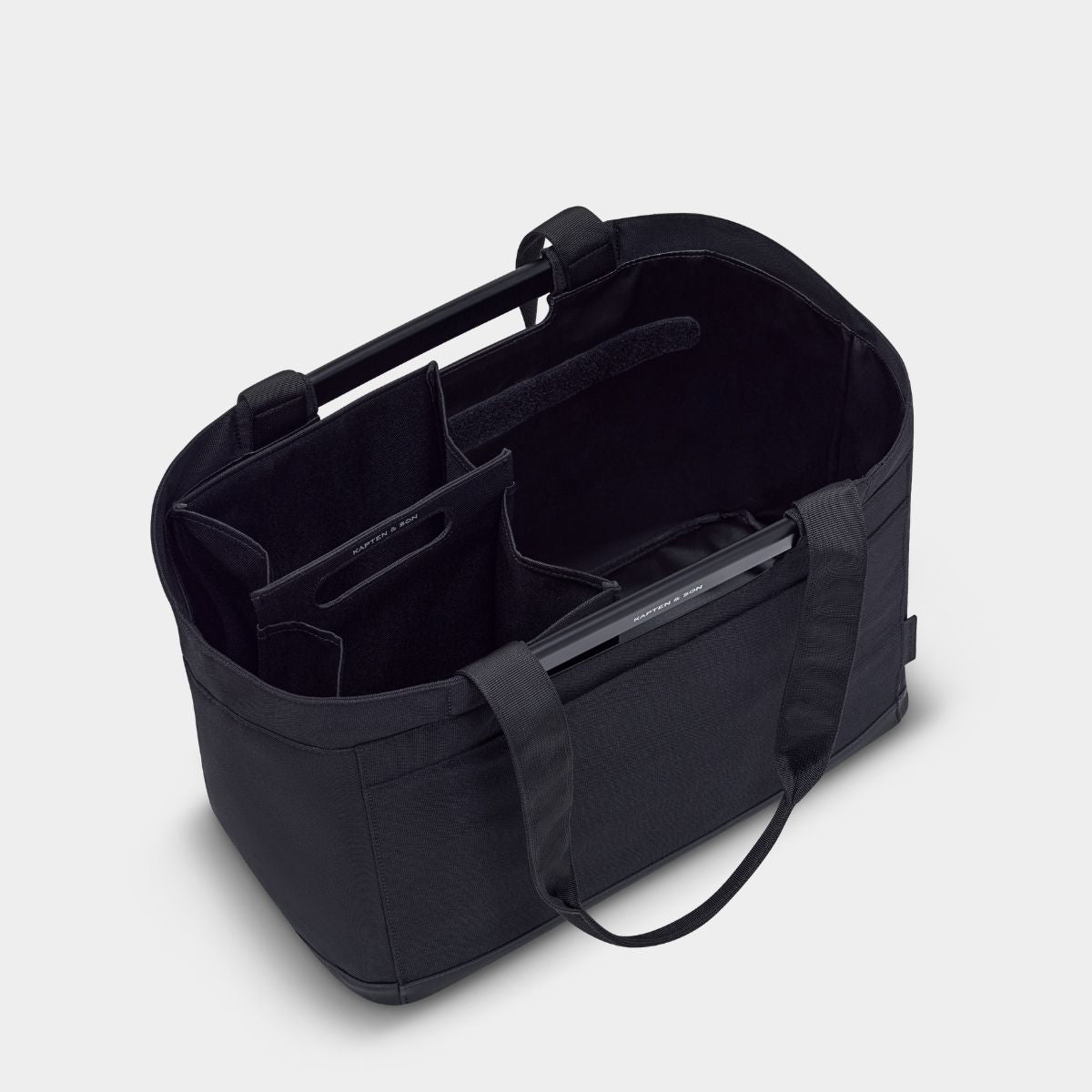 Black tote bag with compartments on a light gray background